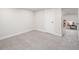 Finished basement showcasing new carpet and a door leading to another room at 3047 N Milwaukee St, Denver, CO 80205