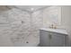 Modern bathroom features a tiled shower with glass door and a vanity with gold fixtures at 3047 N Milwaukee St, Denver, CO 80205