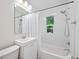 Bright bathroom features subway tile, new shower, and a white vanity with plenty of storage at 3047 N Milwaukee St, Denver, CO 80205