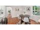 Stylish dining room features hardwood floors, a modern round table, and seamlessly connects to the kitchen at 3047 N Milwaukee St, Denver, CO 80205