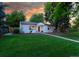Well-kept home with a large lawn, mature trees, and a welcoming front entrance at 3047 N Milwaukee St, Denver, CO 80205