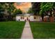 Charming home with a well-manicured front yard and a walkway leading to the front door at 3047 N Milwaukee St, Denver, CO 80205