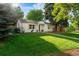 Inviting single story home features a lush green lawn and well-maintained landscaping with mature shade trees at 3047 N Milwaukee St, Denver, CO 80205