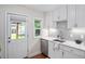Modern kitchen featuring white cabinets, stainless steel appliances, granite countertops, and wood flooring at 3047 N Milwaukee St, Denver, CO 80205