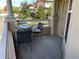 A private balcony with a table and chairs, ideal for outdoor relaxing at 9557 W San Juan Cir # 207, Littleton, CO 80128