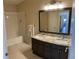 Bathroom featuring double vanity with granite countertop and large mirror at 9557 W San Juan Cir # 207, Littleton, CO 80128