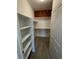 Spacious walk-in closet with custom shelving for optimal storage at 9557 W San Juan Cir # 207, Littleton, CO 80128