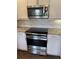 This kitchen features stainless steel appliances, modern cabinetry and granite countertops at 9557 W San Juan Cir # 207, Littleton, CO 80128