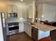 Modern kitchen with stainless steel appliances and plenty of counter space at 9557 W San Juan Cir # 207, Littleton, CO 80128