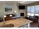 Open-concept living room with fireplace and kitchen island at 9557 W San Juan Cir # 207, Littleton, CO 80128