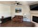 Cozy living room features a fireplace, ceiling fan, and stylish decor at 9557 W San Juan Cir # 207, Littleton, CO 80128