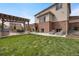 Expansive backyard showcases a pergola, outdoor dining area, and green lawn, perfect for relaxation and gatherings at 17124 Mariposa St, Broomfield, CO 80023