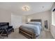 The bedroom has a decorative chandelier, a large bed with a wooden frame and a dark blue armchair at 17124 Mariposa St, Broomfield, CO 80023