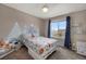 Charming bedroom with mountain mural, a bed with rocket sheets and a big window at 17124 Mariposa St, Broomfield, CO 80023