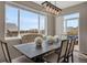 Elegant dining area with a large window, stylish lighting, and comfortable seating at 17124 Mariposa St, Broomfield, CO 80023