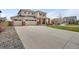 Classic home with a three-car garage, long driveway, and neatly landscaped front yard, offering curb appeal at 17124 Mariposa St, Broomfield, CO 80023