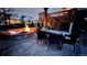 Backyard fire pit with dining and lounge area and wooden pergola at 17124 Mariposa St, Broomfield, CO 80023