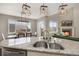 Modern kitchen and dining room with granite countertops, stainless steel appliances, and stylish lighting at 17124 Mariposa St, Broomfield, CO 80023