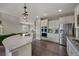 Bright modern kitchen featuring stainless steel appliances, granite countertops, and white cabinets at 17124 Mariposa St, Broomfield, CO 80023