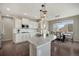 Open kitchen and dining room with white cabinets, granite countertops, and stainless steel appliances at 17124 Mariposa St, Broomfield, CO 80023