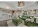 Open-concept living room with modern decor, a fireplace, a staircase, and adjoined kitchen at 17124 Mariposa St, Broomfield, CO 80023
