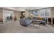Spacious living room featuring a large sectional sofa, stylish decor, and easy access to office and gym areas at 17124 Mariposa St, Broomfield, CO 80023