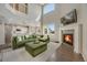 Spacious living room featuring a fireplace, high ceilings, large windows, and comfortable seating at 17124 Mariposa St, Broomfield, CO 80023