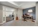 Comfortable office area adjacent to home gym, with dark accent wall and ample sunlight at 17124 Mariposa St, Broomfield, CO 80023