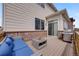 Inviting patio with a stainless steel grill, brick accents, and comfortable outdoor seating under a bright, sunny sky at 17124 Mariposa St, Broomfield, CO 80023