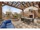 Charming pergola with outdoor seating area, stylish fire pit, and views of the surrounding neighborhood at 17124 Mariposa St, Broomfield, CO 80023