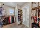 Walk-in closet with custom shelving and an array of hanging clothing, shoes, and storage bins at 17124 Mariposa St, Broomfield, CO 80023