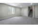 Finished basement space with neutral carpet, trim and a staircase leading to another level at 24801 E 33Rd Dr, Aurora, CO 80019