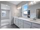 Bathroom featuring a double sink vanity with modern hardware and finishes at 24801 E 33Rd Dr, Aurora, CO 80019