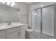 Bathroom featuring a glass enclosed shower and modern fixtures, with geometric tile flooring at 24801 E 33Rd Dr, Aurora, CO 80019