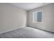 Bedroom with neutral carpet and walls, with a window providing natural light at 24801 E 33Rd Dr, Aurora, CO 80019