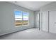 Bedroom features a large window and a sliding door closet at 24801 E 33Rd Dr, Aurora, CO 80019