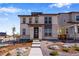 Contemporary two-story home featuring modern architecture and professionally landscaped front yard at 24801 E 33Rd Dr, Aurora, CO 80019