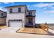 New two-story home with a two car garage, newly poured driveway and lake view at 24801 E 33Rd Dr, Aurora, CO 80019