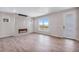 Beautiful living room with contemporary fireplace, large windows, and stylish front door at 24801 E 33Rd Dr, Aurora, CO 80019