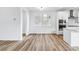 Dining area with wood floors and views of the modern kitchen at 2031 Generations Aly, Brighton, CO 80601