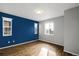 Spacious bedroom with blue accent wall and wood flooring at 24263 E 41St Ave, Aurora, CO 80019