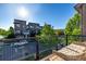 Balcony view of the street from a wood balcony featuring black iron railings and outdoor seating at 10305 Martin Luther King Blvd, Denver, CO 80238