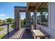 View of the wood balcony featuring black iron railings and outdoor seating with a brick facade at 10305 Martin Luther King Blvd, Denver, CO 80238