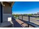 Spacious wood balcony with black iron railings offering open street views and a seating area at 10305 Martin Luther King Blvd, Denver, CO 80238