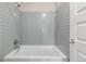 This bathroom features light gray subway tiles in the bathtub/shower combo at 10305 Martin Luther King Blvd, Denver, CO 80238