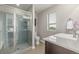 Bathroom boasts a glass enclosed shower, a large window that brings in light, and a modern sink at 10305 Martin Luther King Blvd, Denver, CO 80238