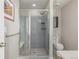 The bathroom showcases a large shower with a glass door, bench, and gray tile surround at 10305 Martin Luther King Blvd, Denver, CO 80238