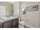 Half bathroom features granite countertop and sink with a window for natural light at 10305 Martin Luther King Blvd, Denver, CO 80238
