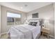 This bedroom has a window that offers a view, a cozy bed, and two nightstands with lamps at 10305 Martin Luther King Blvd, Denver, CO 80238
