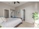 This bedroom features neutral walls, a ceiling fan, and doors leading to a closet and bathroom at 10305 Martin Luther King Blvd, Denver, CO 80238